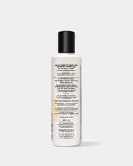SEEN Shampoo 8.6oz bottle with scented label, featuring a sleek design and clear branding for beauty haircare.