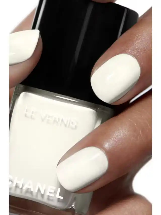 Chanel Vernis Nail Colour bottles in various shades, new in box, showcasing vibrant, glossy nail polish options.