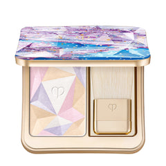 Clé de Peau Beauté Luminizing Face Enhancer in various shades, new in box, showcasing a compact with a luminous highlighter powder.
