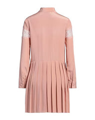 Red Valentino blush shirt dress hanging on a hanger, showcasing its soft fabric and stylish design.