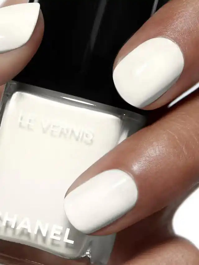 Chanel Vernis Nail Colour bottles in various shades, displaying shiny, colorful nail polish for beauty and manicure purposes.