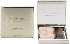 Clé de Peau Beauté Luminizing Face Enhancer in various shades, featuring a sleek compact with shimmering powder for radiant skin.