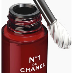 Chanel N°1 de Chanel revitalizing eye serum bottle with sleek packaging, 15ml size, for reducing signs of aging around eyes.