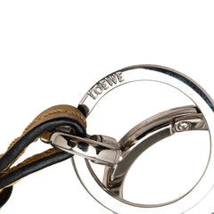 LOEWE green leather Anagram key ring and bag charm with gold-tone hardware, styled on a neutral background.
