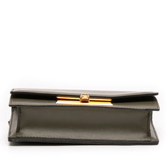 Alexander McQueen mini leather skull lock top handle bag in vibrant green with structured design and gold-tone hardware.