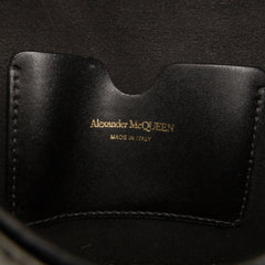 Alexander McQueen mini leather skull lock top handle bag in vibrant green with skull detailing and sleek design.