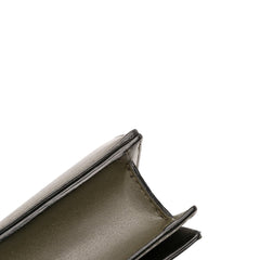 Alexander McQueen mini leather skull lock top handle bag in vibrant green, featuring a distinctive skull detail and compact design.