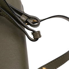 Alexander McQueen Mini leather skull lock top handle bag in vibrant green with detailed hardware and sleek design.