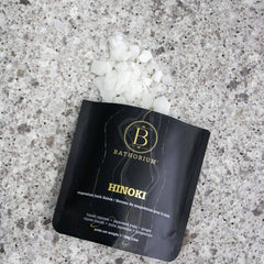 Bathorium Hinoki Magnesium Flake Bath Soak in a container, showcasing the natural magnesium flakes for relaxing bath experiences.