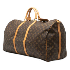 Louis Vuitton Monogram Keepall Bandoulière 60 brown travel bag with leather trim and adjustable strap.