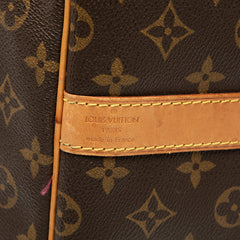 Louis Vuitton Monogram Keepall Bandoulière 60 brown travel bag with leather handles and monogram canvas.