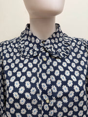 The Great Cotton Daisy Blouse showing a lightweight, white cotton top with floral daisy print and relaxed fit on hanger.