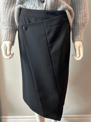 Black Acne asymmetrical hoist skirt in size 38/6, shown on a hanger with detailed fabric texture and modern design.