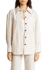 BAUM UND PFERDGARTEN Mahina organic cotton eyelet shirt jacket displayed on a hanger, featuring intricate eyelet detailing and lightweight fabric.