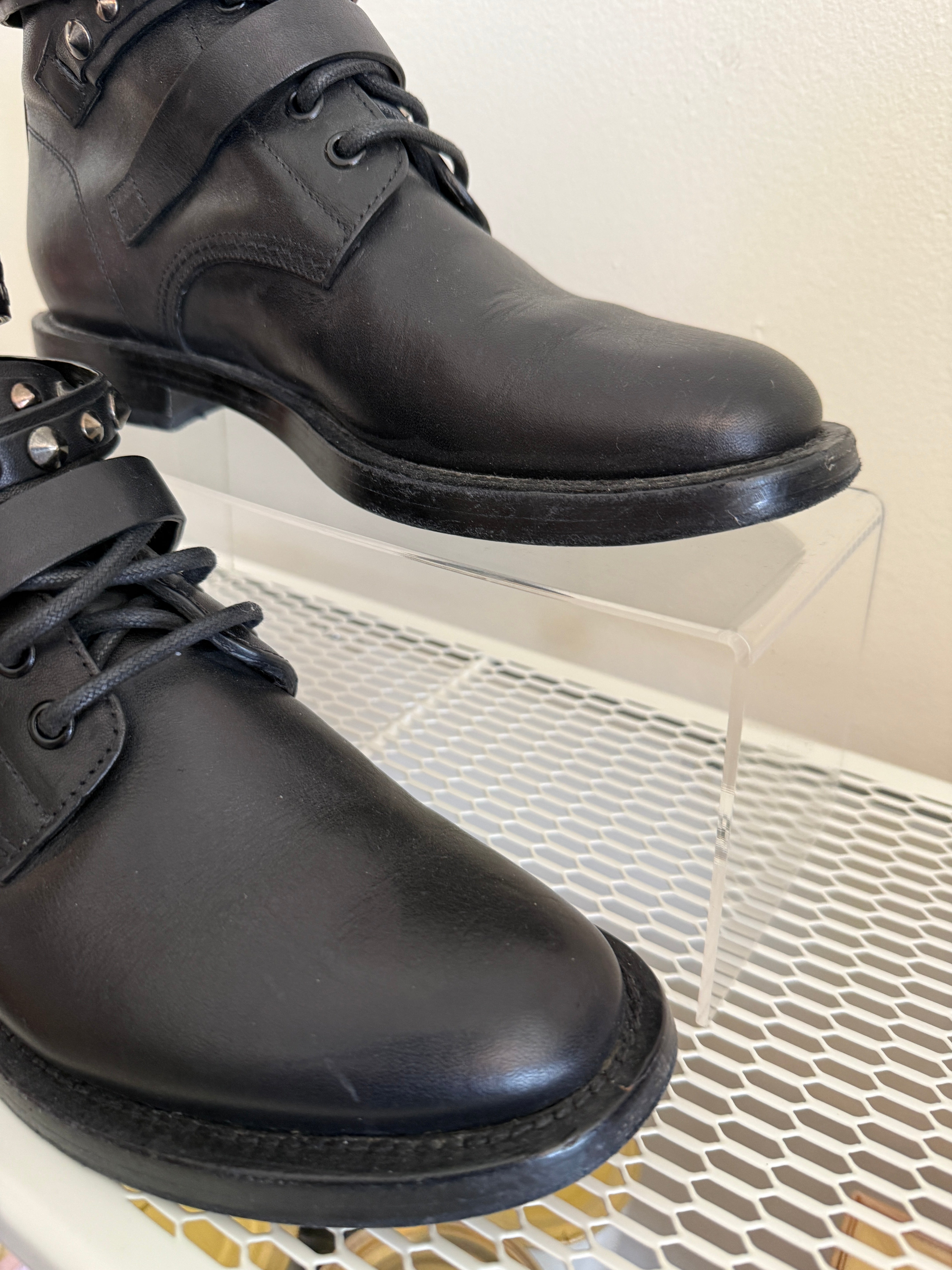 Yves Saint Laurent Ranger Stud Boot with wrap straps, size 37.5, featuring black leather and silver stud detailing.