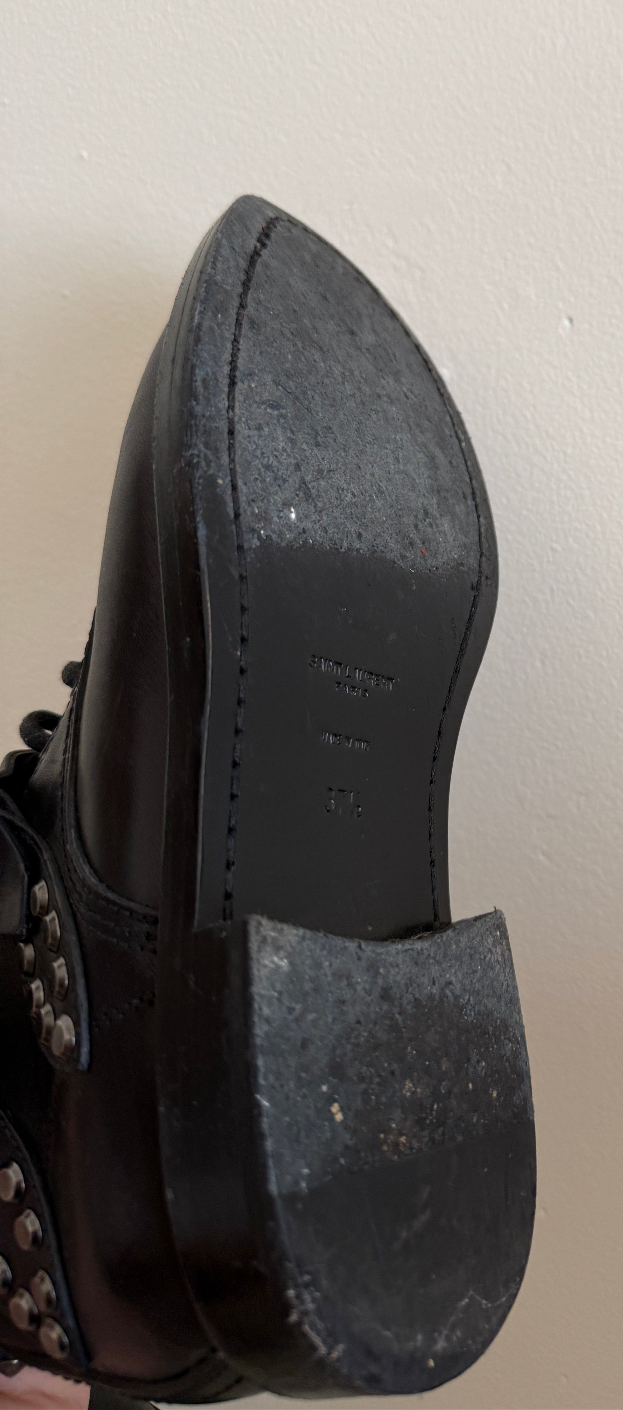Yves Saint Laurent Ranger Stud Boot with wrap straps in size 37.5, featuring black leather with metallic stud accents.