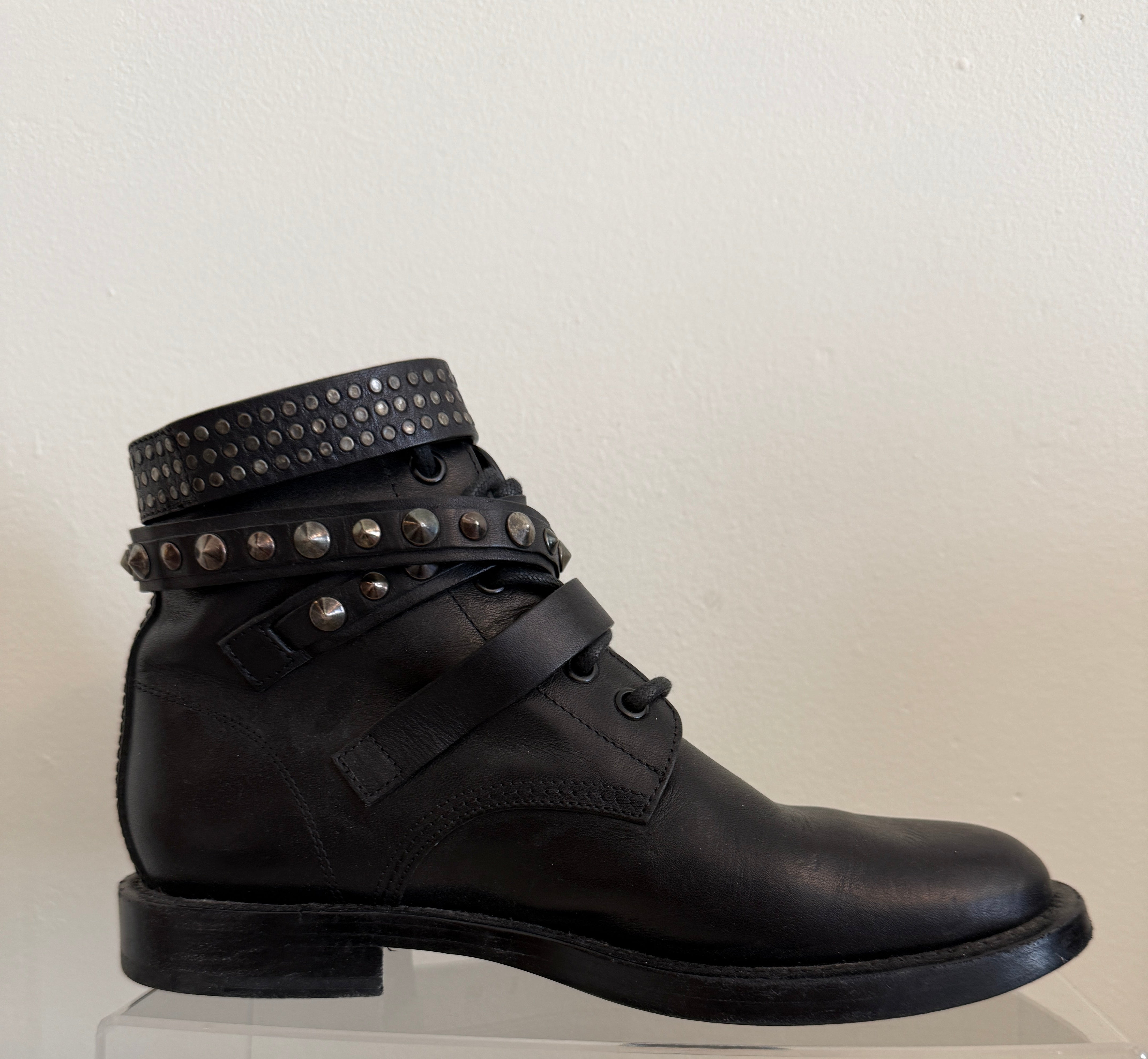 Yves Saint Laurent Ranger Stud Boots in size 37.5 with wrap strap design, featuring studded detailing and black leather finish.