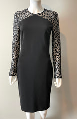 Stella McCartney mini dress in size IT44/US6, elegant black clothing with stylish design, displayed on a hanger.