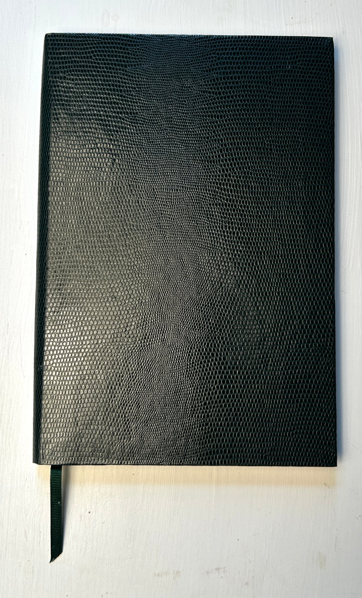 Dark green Sloane Stationery ruled journal with a hardcover and gold foil detailing, designed for home use.