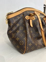 Louis Vuitton Monogram Tivoli GM bag with leather handles and monogram canvas, showing front view and gold-tone hardware.