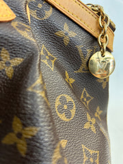 Louis Vuitton Monogram Tivoli GM bag with leather handles and gold hardware, featuring the iconic LV monogram canvas.