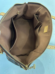 Louis Vuitton Monogram Tivoli GM bag with leather handles and spacious interior, featuring classic LV monogram canvas and gold-tone hardware.
