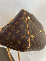 Louis Vuitton Monogram Tivoli GM bag with leather handles and monogram canvas, displayed on a neutral background.
