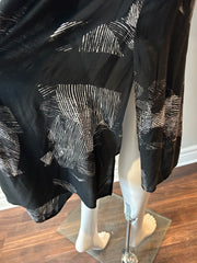 Raquel Allegra XL graphic print dress displayed on model, featuring vibrant patterns and flowing fabric.