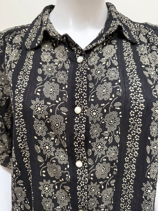 Light gray cotton blouse from The Great, featuring a relaxed fit and subtle stitching details, displayed on a hanger.