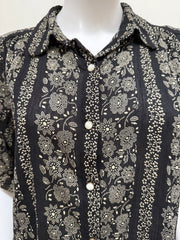 Light gray cotton blouse from The Great, featuring a relaxed fit and subtle stitching details, displayed on a hanger.