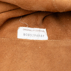 Bottega Veneta crackled calfskin The Pouch bag in a sleek, textured design with a fold-over flap and subtle branding.