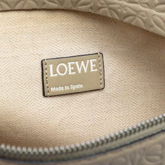 LOEWE Embossed Anagram Leather Repeat T clutch bag with sleek design and textured leather finish.