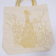 Christian Dior J'Adore tote bag in beige with gold accents, featuring a structured design and Dior branding on the front.