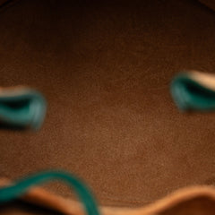 Small Bottega Veneta pony hair drop bucket bag in vibrant green with a sleek design and subtle branding.