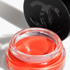 Chanel N°1 de Chanel Lip and Cheek Balm in Vibrant Coral, showing the sleek packaging and vibrant product inside.