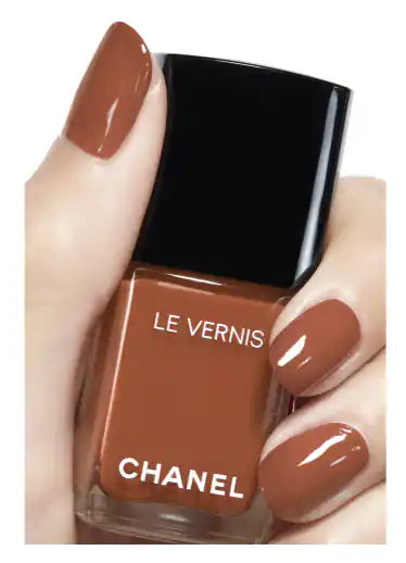 Chanel Vernis nail color bottles in various shades, showcasing sleek glass packaging and colorful polish options.
