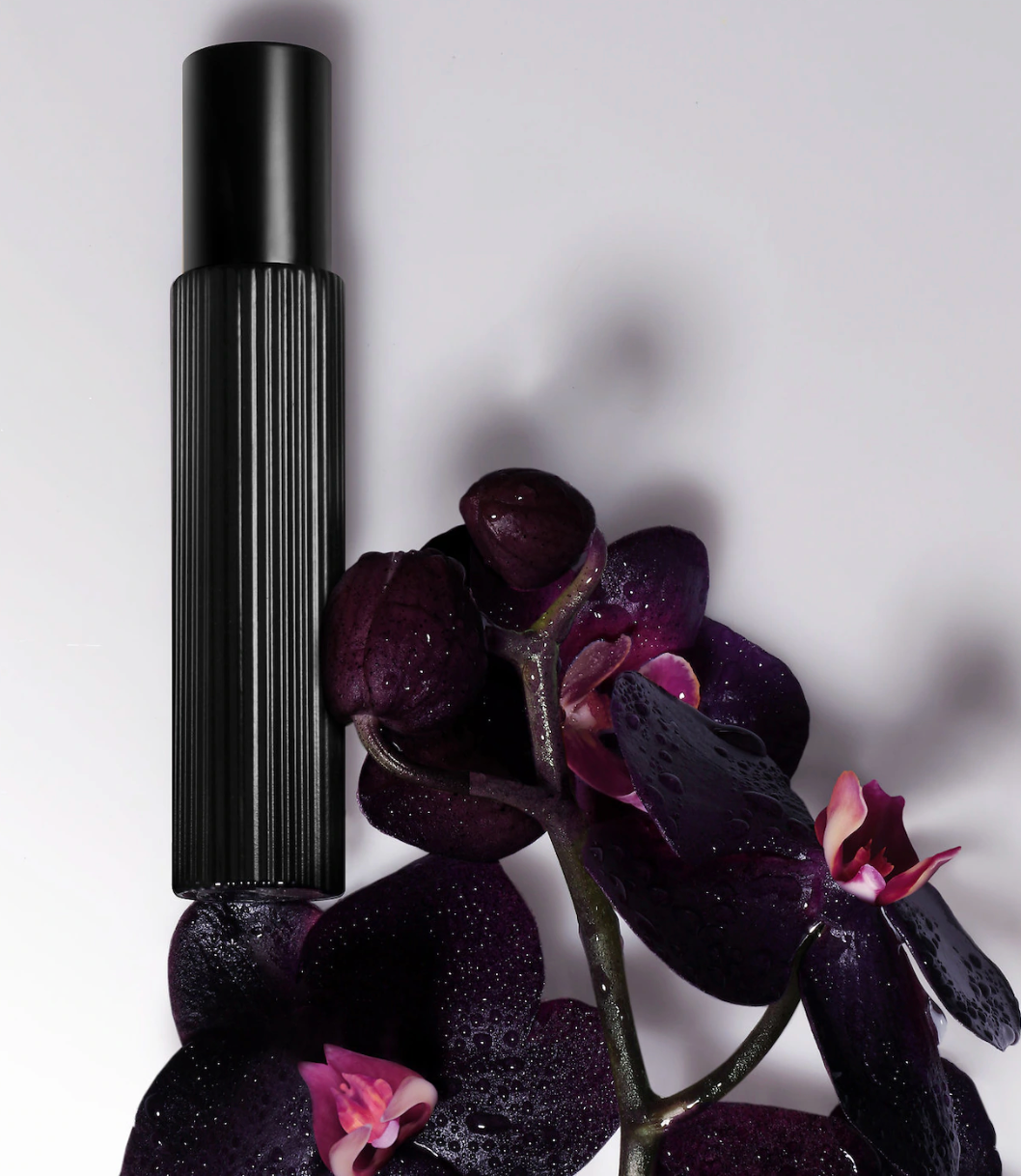 Tom Ford Black Orchid Eau de Parfum travel spray featuring black truffle and ylang ylang, showcasing elegant fragrance packaging.