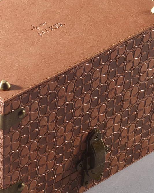 The Maker leather jewelry box with compartments, showing a sleek brown leather exterior and detailed stitching.
