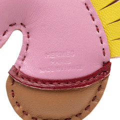 Hermès Milo Lambskin Geegee Camail Bag Charm in pink, featuring soft lambskin leather and decorative design for accessories.