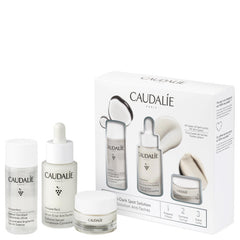 Caudalie Vinoperfect Brightening Solution Set with skincare bottles and tubes for reducing dark spots and evening skin tone.