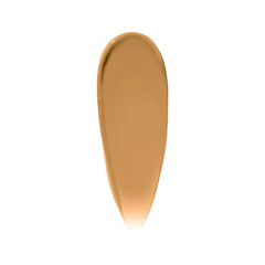 Bobbi Brown Vitamin Enriched Hydrating Skin Tint SPF 15 bottle with hyaluronic acid, shades, and a golden cap on a white background