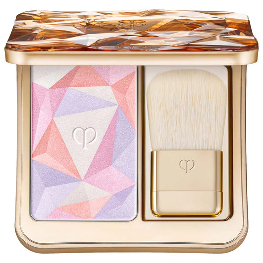 Shimmery Clé de Peau Beauté Luminizing Face Enhancer in various shades, highlighting a sleek compact with a luminous glow.