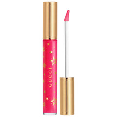 Gucci Gloss à Lèvres hydrating plumping lip gloss in various shades, featuring a sleek tube and shiny finish.