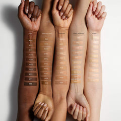 Fenty Beauty Soft’Lit Luminous Hydrating Foundation bottle in various shades, close-up shot showing the product label and packaging.