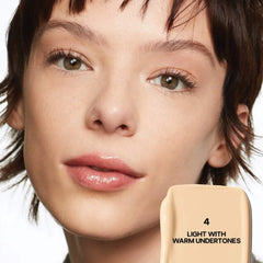 Saie Slip Tint Radiant All-Over Concealer in multiple shades, featuring a sleek tube and applicator for natural skin coverage.