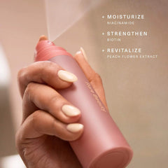 Rare Beauty Find Comfort body and hair fragrance mist with niacinamide, featuring a sleek bottle with a minimalist design.
