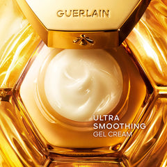 Guerlain Abeille Royale Youth Repair Eye Cream jar with gold accents and product label, close-up view of the beauty product.