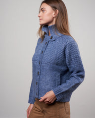 The Great shrunken Hearth cardigan in saltwater blue, size S, displayed on a hanger with a close-up of the knit fabric.