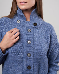 The Great shrunken hearth cardigan in saltwater blue, size S, shown on a model, featuring a cozy, fitted knit design.
