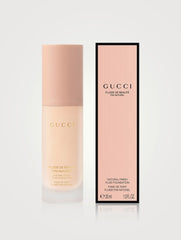 Gucci natural finish fluid foundation bottle with multiple shades, showcasing a sleek, elegant packaging design.